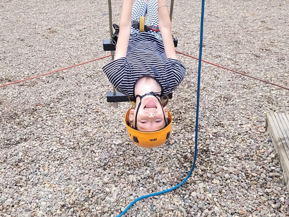 Young person taking part in a rope climbing activity