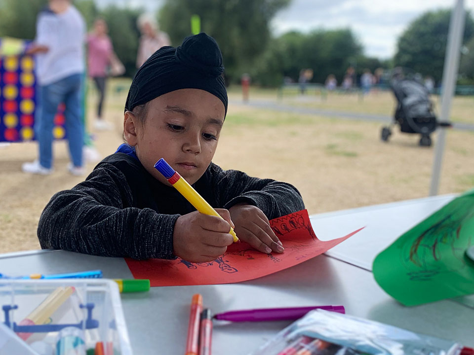 Young person taking part in an art project at Go Play's summer event