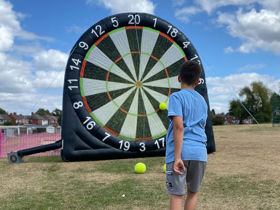 Young person playing inflatable darts