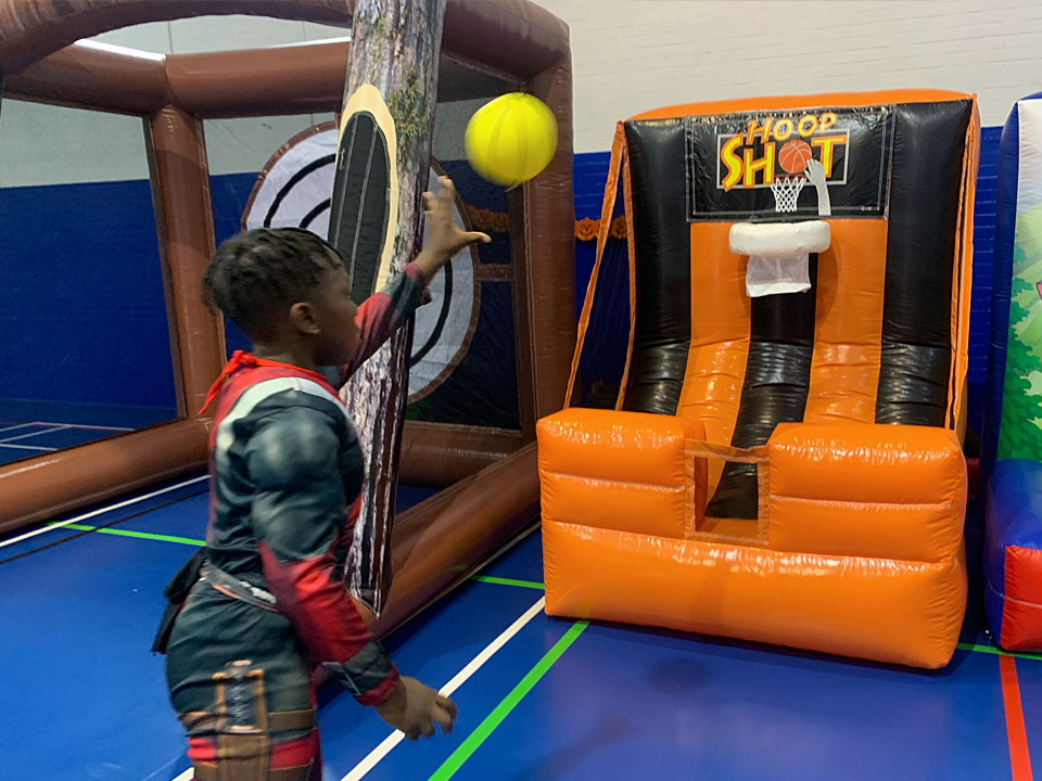 Boy playing inflatable basketball