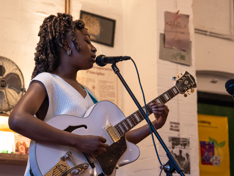 Singer with a guitar performing live