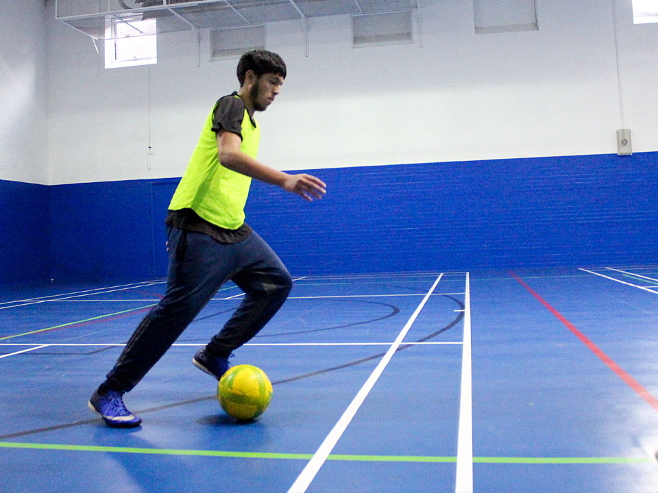 Teenager playing in an indoor football tournament