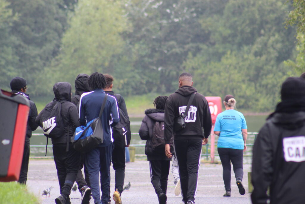 Group of young people walking as part of the reservoir trip for the brotherhood collective